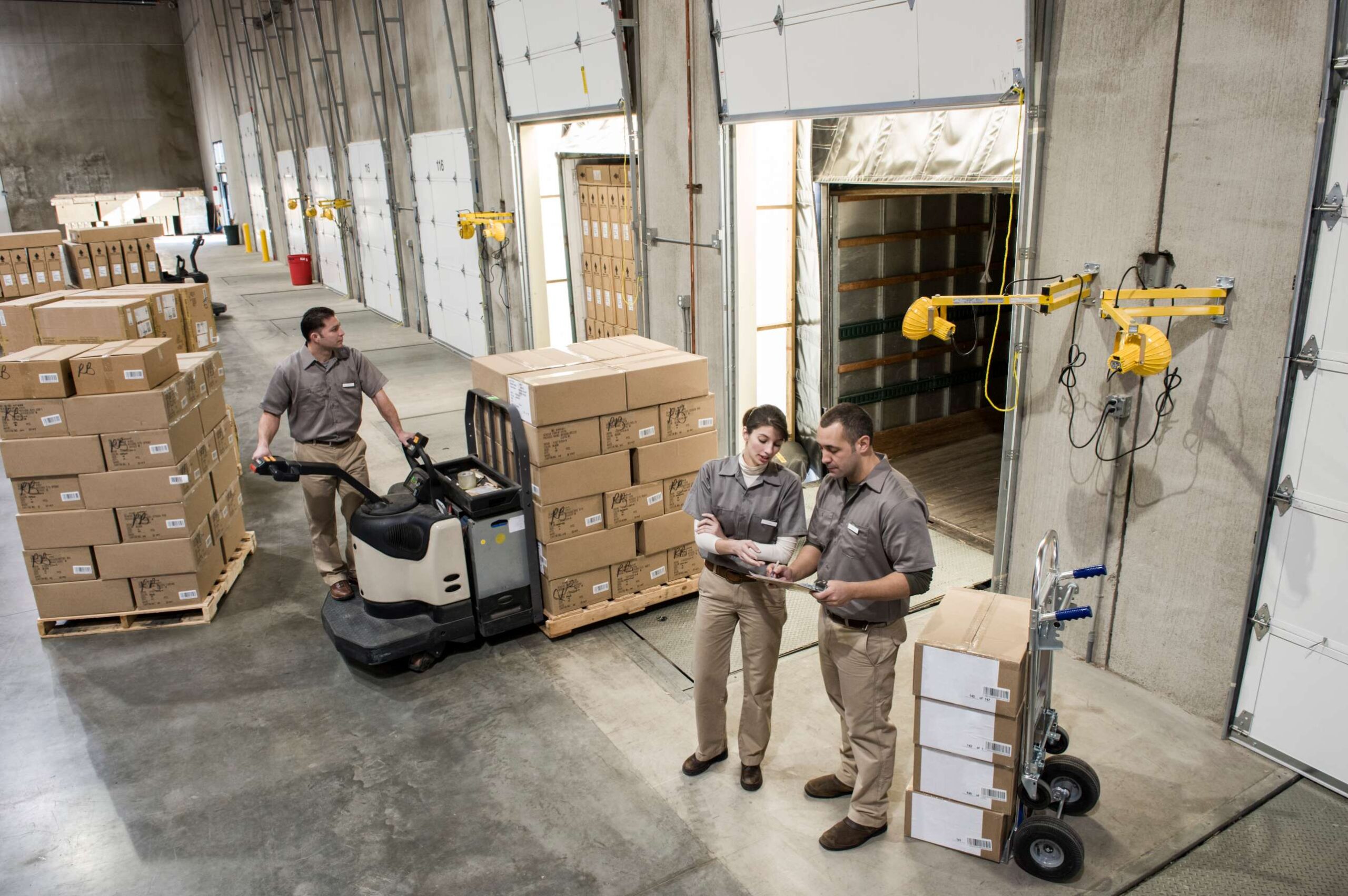 uniformed-warehouse-workers-loading-boxed-products-2022-03-04-02-39-18-utc
