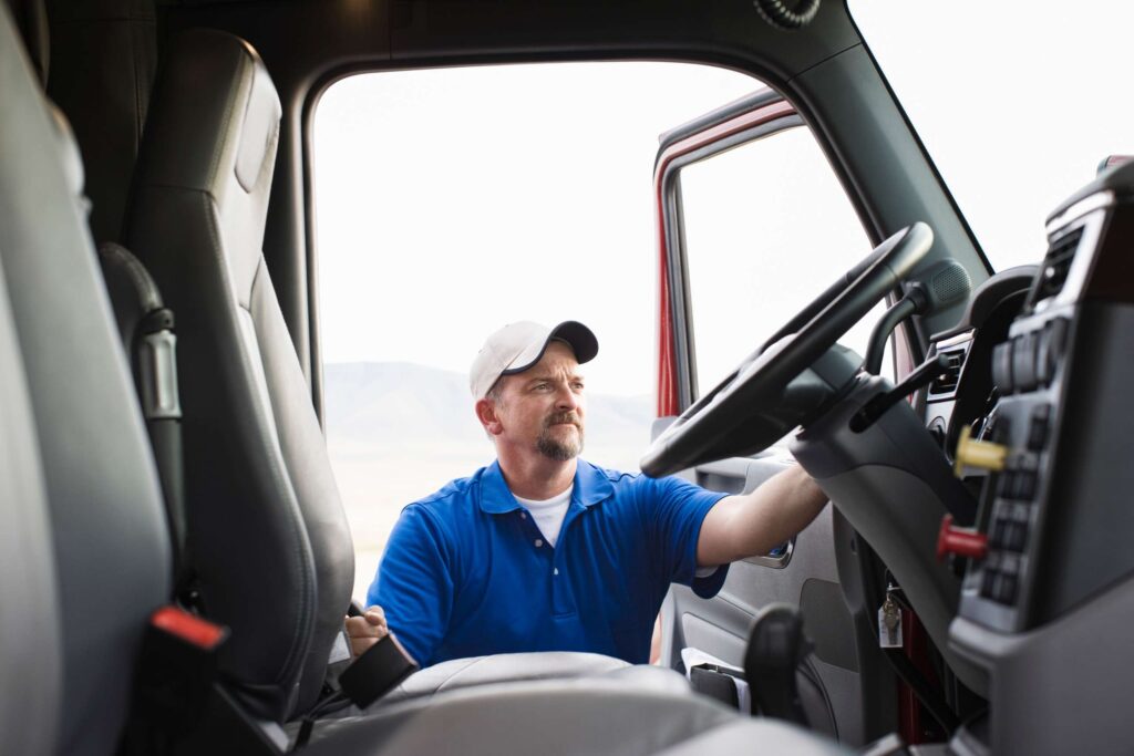 driver-getting-into-the-cab-of-a-commercial-truck-2022-03-04-02-19-26-utc