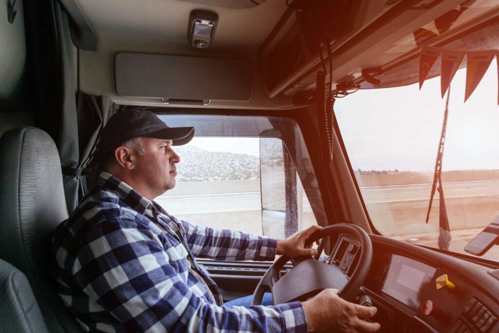 driver-in-cabin-of-big-modern-truck-vehicle-on-hig-2022-11-12-10-37-17-utc